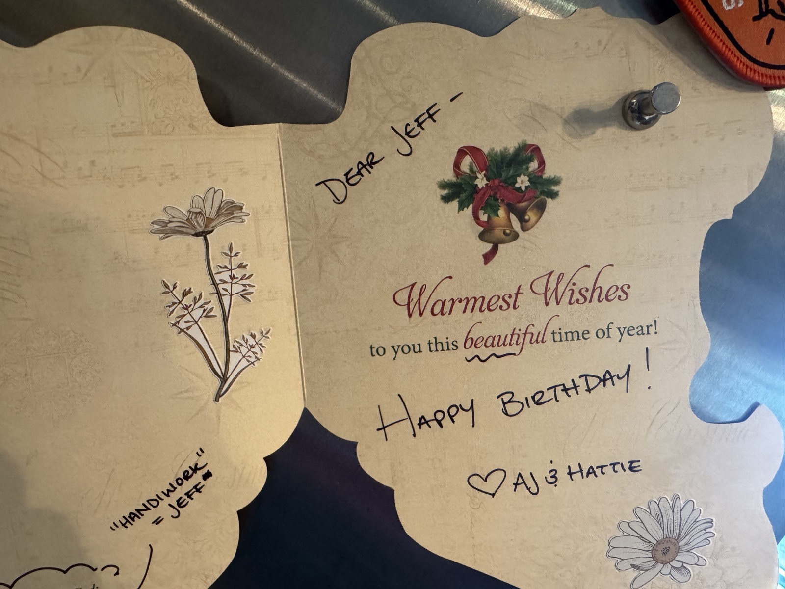 A Christmas card repurposed as a birthday card, handwritten: "Dear Jeff — Happy Birthday! AJ & Hattie"